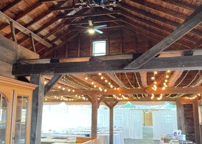 Charming rustic wedding venue with elegant lighting and wooden interior. Perfect for memorable outdo.