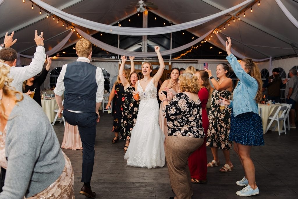 Wedding celebration at Lupines & Lace wedding venue, with guests dancing and enjoying the event.