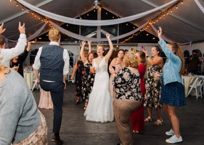 Wedding celebration at Lupines & Lace wedding venue, with guests dancing and enjoying the event.